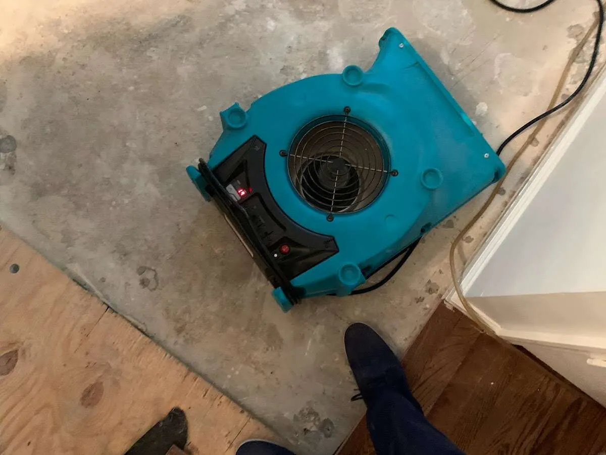 Air mover drying subfloor during Commercial Water Damage Restoration in Rogers